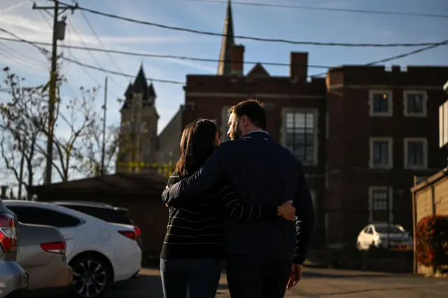 JD Vance and his wife Usha embrace after casting their votes in Cincinnati