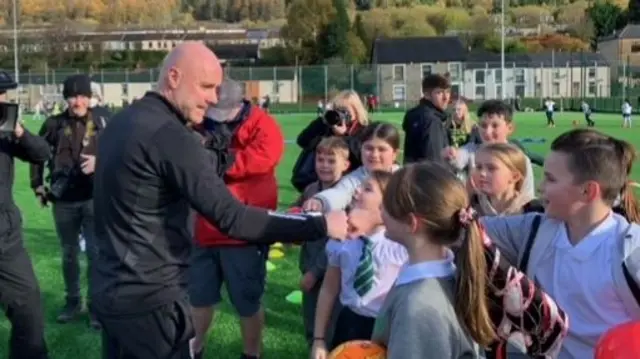 Rob Page meeting school kids