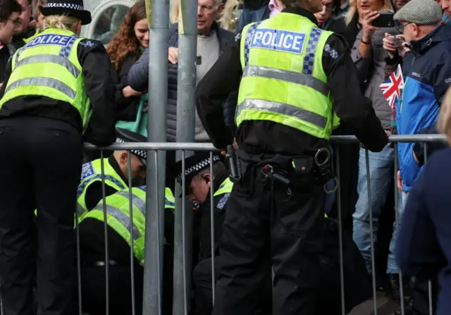 Police restrain egg thrower