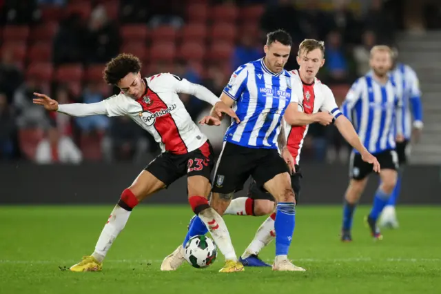 Samuel Edozie and James Ward-Prowse fight for the ball