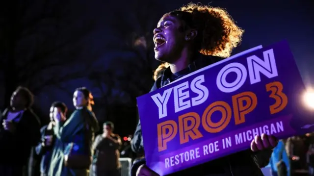 Michigan Jaelynn Smith, a freshman at Michigan State University, holds a sign in support of Proposal 3, a ballot measure which would codify abortion rights, during a 'get out the vote' rally at MSU, the night before the midterm election, in East Lansing, Michigan, U.S., November 7, 2022.