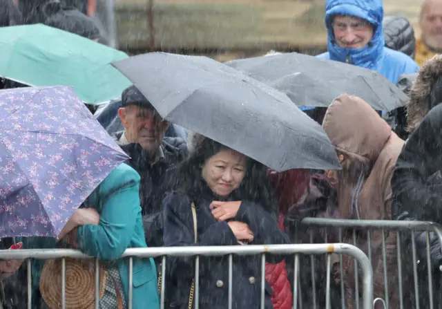 Crowds at York Minster sheltering from the rain