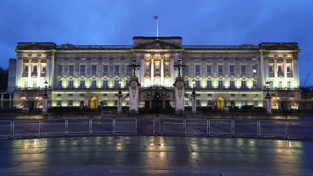 General exterior view of Buckingham Palace on a rainy night in London