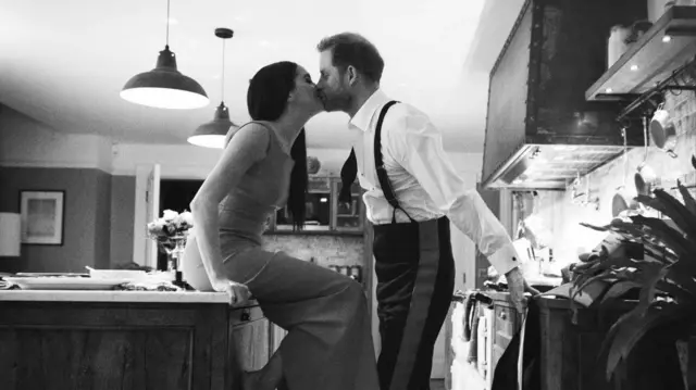 Harry and Meghan kissing in a kitchen