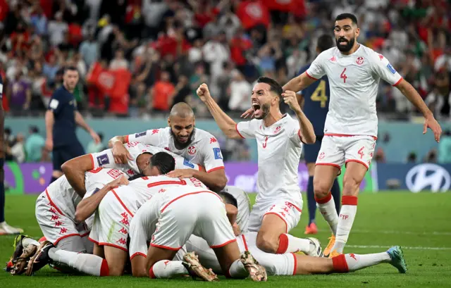 Wahbi Khazri of Tunisia celebrates with teammates after scoring their team's first goal during the FIFA World Cup Qatar 2022 Group D match between Tunisia and France at Education City Stadium