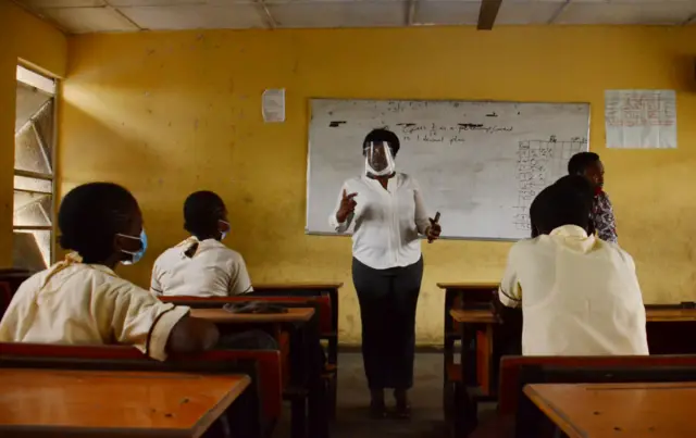 A teacher with a face mask gives a lesson to students at Ireti Junior Grammar School, Ikoyi, Lagos on August 3, 2020