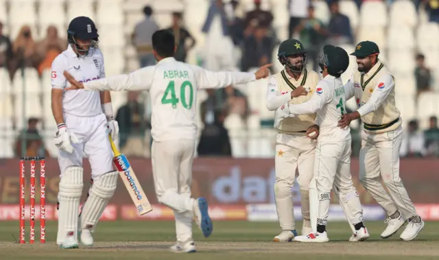 Abdullah Shafique of Pakistan is congratulated on catching Joe Root of England during day two of the Second Test Match between Pakistan and England at Multan Cricket Stadium on December 10, 2022 in Multan, Pakistan.