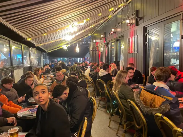 Fans fill a bar in central Paris