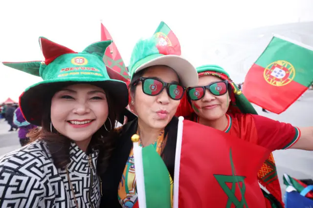 Portugal fans waving a Moroccan flag