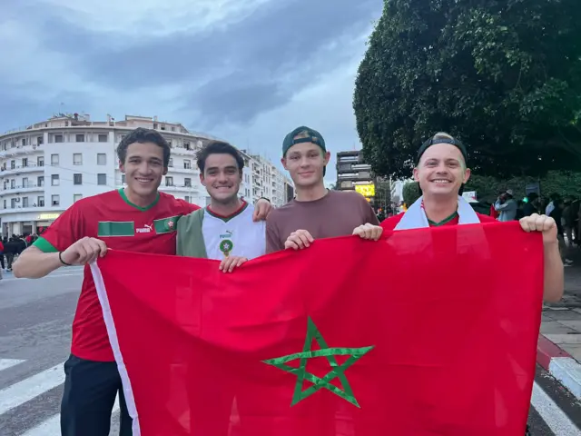 A group of exchange students pose with a Morocco flag