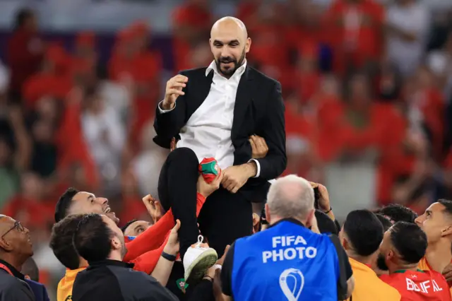 Walid Regragui, Head Coach of Morocco, celebrates with the team