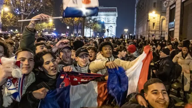 French supporters celebrate their team winning the FIFA World Cup 2022 quarter final match between France and England, on the Champs Elysees avenue in Paris, France, 10 December 2022.