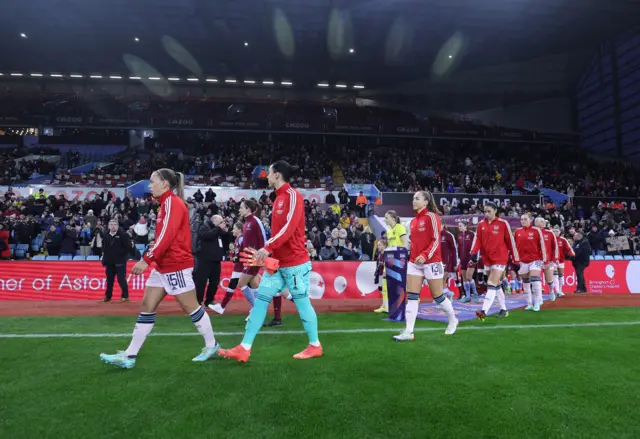 Aston Villa and Arsenal players enter the pitch