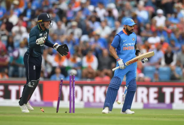 India batsman Virat Kohli reacts as Jos Buttler celebrates after Rashid had bowled Kohli for 71 runs during 3rd ODI Royal London One Day match between England and India at Headingley on July 17, 2018 in Leeds