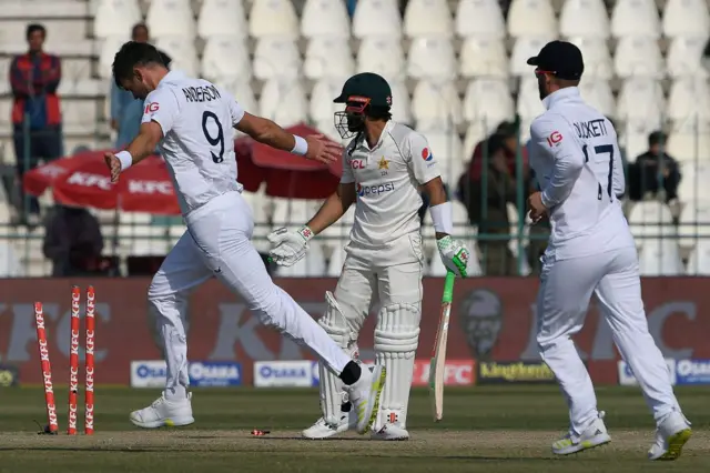 England's James Anderson (L) celebrates after taking the wicket of Pakistan's Mohammad Rizwan (C) during the third day of the second cricket Test match between Pakistan and England at the Multan Cricket Stadium in Multan on December 11, 2022