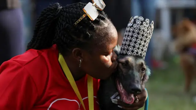 Woman kissing a dog