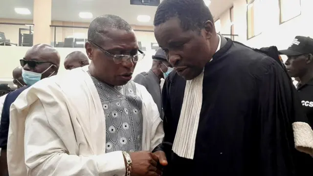 Guinea's former military junta leader Moussa Dadis Camara talks with a lawyer during his trial with ten other men accused of responsibility for the 2009 massacre and mass rape of pro-democracy protesters by forces linked to a former military junta in Conakry, Guinea September 28, 2022