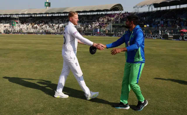 Ben Stokes shaking hands with Babar Azam