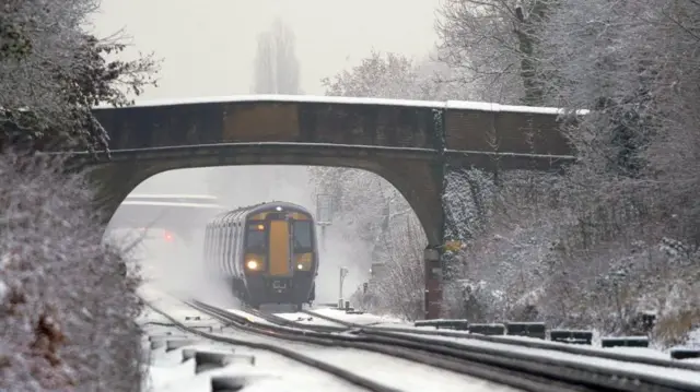 A Southeastern train makes its way through Ashford in Kent as rail services remain disrupted in the icy weather. Snow and ice have swept across parts of the UK, with cold wintry conditions set to continue for days. Picture date: Monday December 12, 2022.