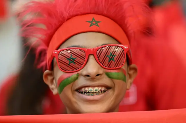 A young Morocco fan watches them beat Portugal at the World Cup.