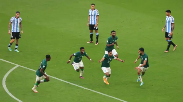 Argentina players watch Saudi Arabia celebrate