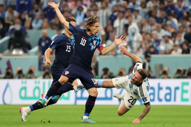 Alexis Mac Allister wins a free-kick from Luka Modric