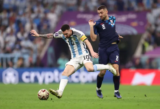 Lionel Messi runs away from Matteo Kovacic