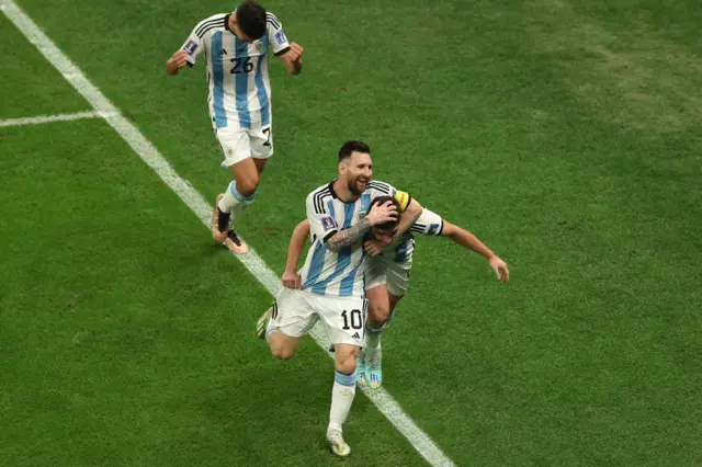 Lionel Messi celebrates with Julian Alvarez