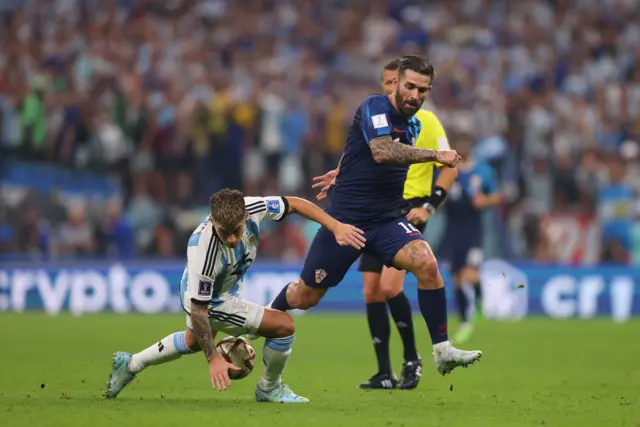 Lisandro Martinez of Argentina is challenged by Marko Livaja of Croatia during the FIFA World Cup Qatar 2022 semi final match between Argentina and Croatia at Lusail Stadium