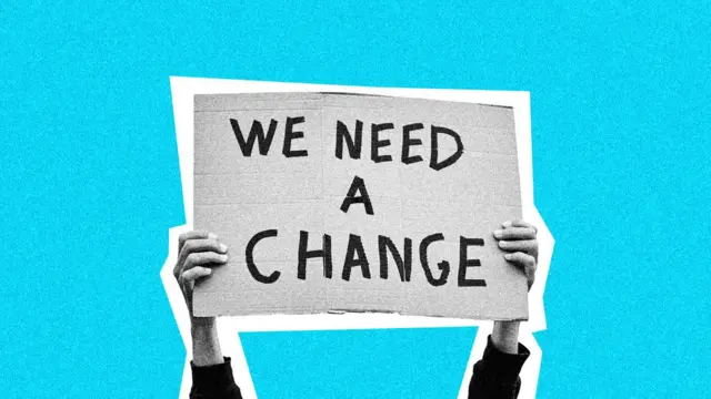 A graphic of a placard reading "We need a change"