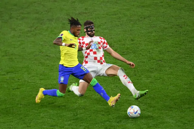 Fred of Brazil battles for possession with Josko Gvardiol of Croatia during the FIFA World Cup Qatar 2022 quarter final match between Croatia and Brazil at Education City Stadium