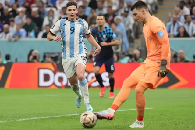 Argentina's Julian Alvarez closes down the Croatia goalkeeper