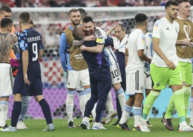 Lionel Messi is mobbed by his Argentina team-mates as they reach the World Cup final