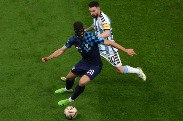 Josko Gvardiol fights for the ball with Lionel Messi during the Qatar 2022 World Cup football semi-final match between Argentina and Croatia at Lusail Stadium in Lusail