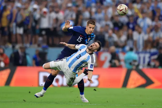 Nicolas Tagliafico of Argentina is challenged by Mario Pasalic of Croatia during the FIFA World Cup Qatar 2022 semi final match between Argentina and Croatia at Lusail Stadium