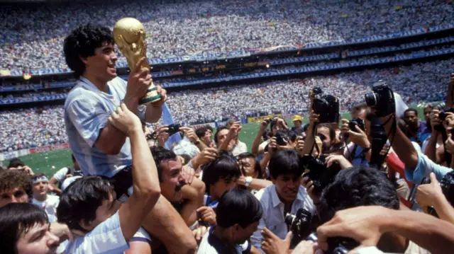 Diego Maradona holds the World Cup trophy in 1986