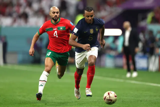 Jules Kounde of France controls the ball against Sofyan Amrabat of Morocco during the FIFA World Cup Qatar 2022 semi final match between France and Morocco