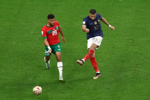 Kylian Mbappe has a shot blocked