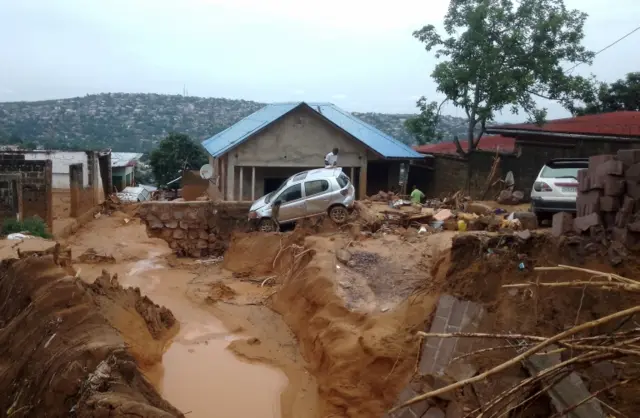 A car is seen stuck after heavy rains caused floods and landslides, on the outskirts of Kinshasa