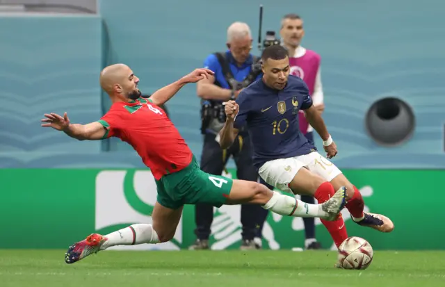 Sofyan Amrabat tackles Kylian Mbappe