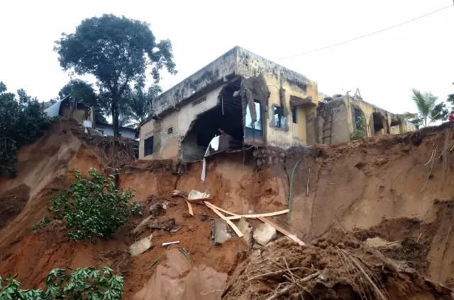 A damaged house is seen after heavy rains caused floods and landslides, on the outskirts of Kinshasa