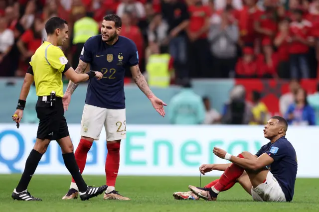 Kylian Mbappe ties his laces