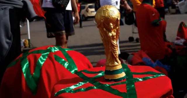 Replica of the World Cup trophy on a Morocco flag in Marrakech