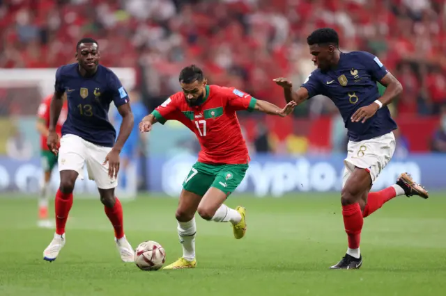 Sofiane Boufal of Morocco controls the ball against Aurelien Tchouameni of France during the FIFA World Cup Qatar 2022 semi final match between France and Morocco