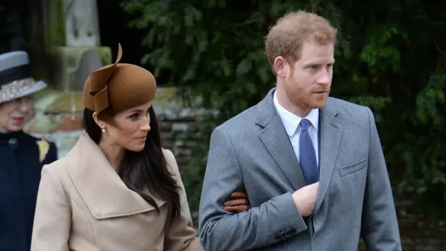 Harry and Meghan walk arm in arm