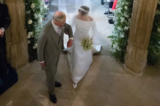 Charles walks Meghan down the aisle at her wedding