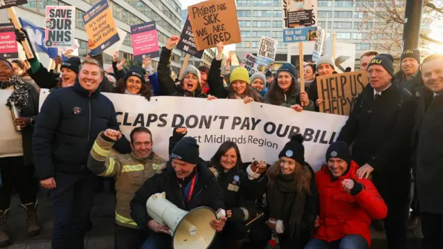 Firefighters belonging to the Fire Brigades Union join nurses on a picket line outside St Thomas' Hospital in central London