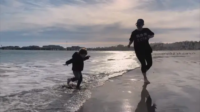 Princess Eugenie and Archie are pictured on the shoreline of a beach