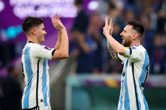 Julian Alvarez of Argentina celebrates with teammate Lionel Messi