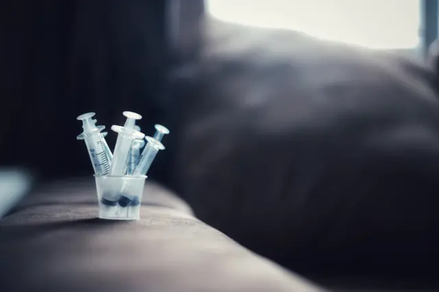 Children hands and syringes for liquid medicine